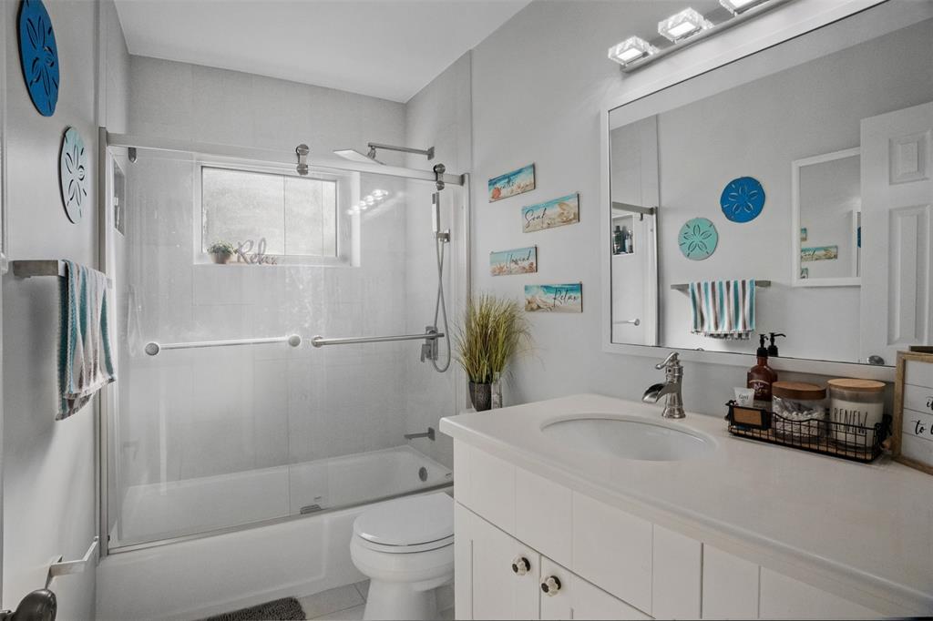 223 Southeast 7th Street Dania Beach, FL 33004 - Photo 30 of 50 a bathroom with a sink a toilet and a mirror