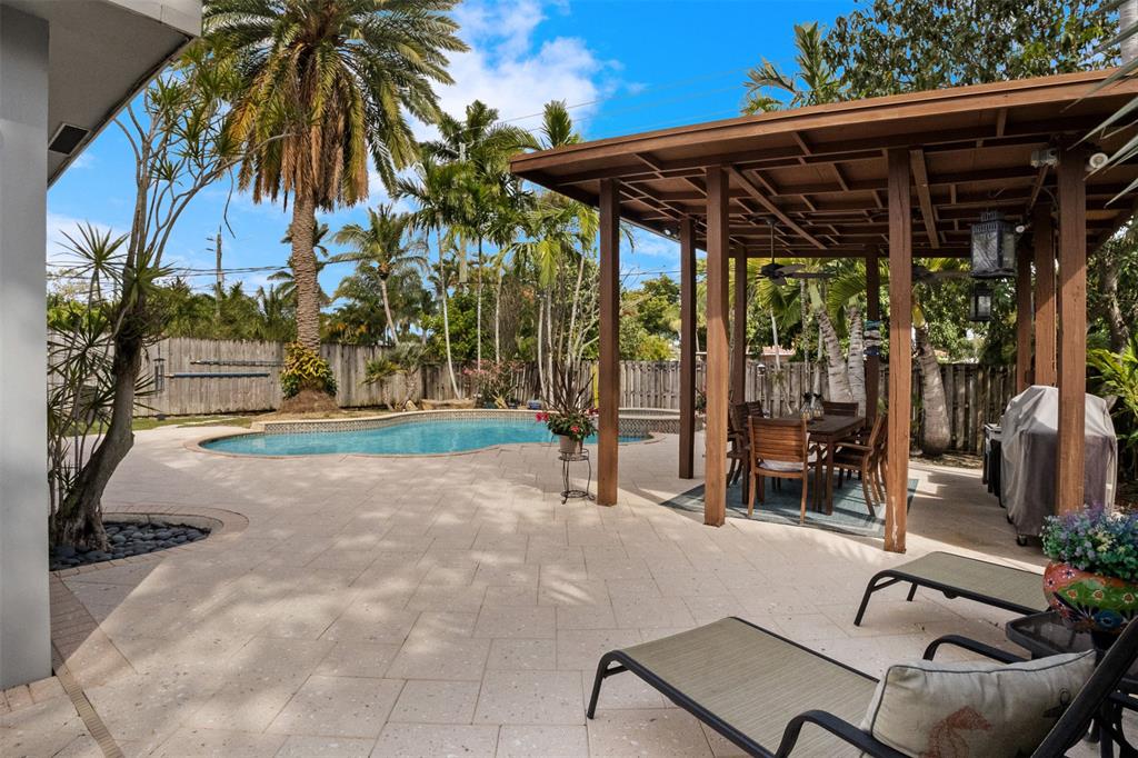 223 Southeast 7th Street Dania Beach, FL 33004 - Photo 39 of 50 a patio with a yard table and chairs