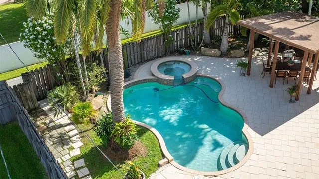 a aerial view of a house with a yard and potted plants
