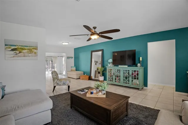 a kitchen with stainless steel appliances kitchen island granite countertop a sink and a refrigerator
