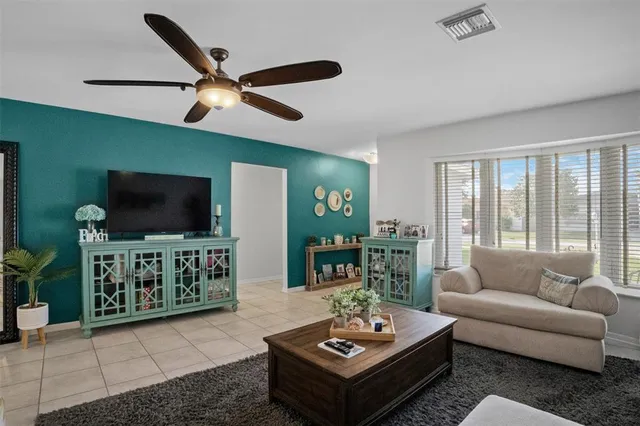 a hall with kitchen countertops a stove and a dining table