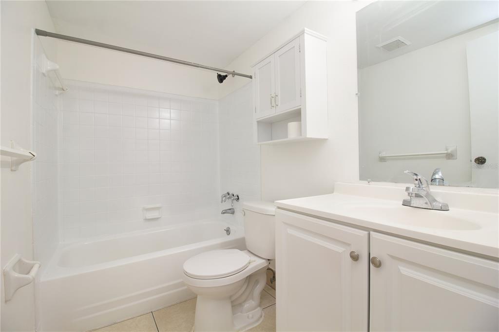 389 South McMullen Booth Road, Unit 12 Clearwater, FL 33759 - Photo 19 of 25 a bathroom with a sink a toilet and shower