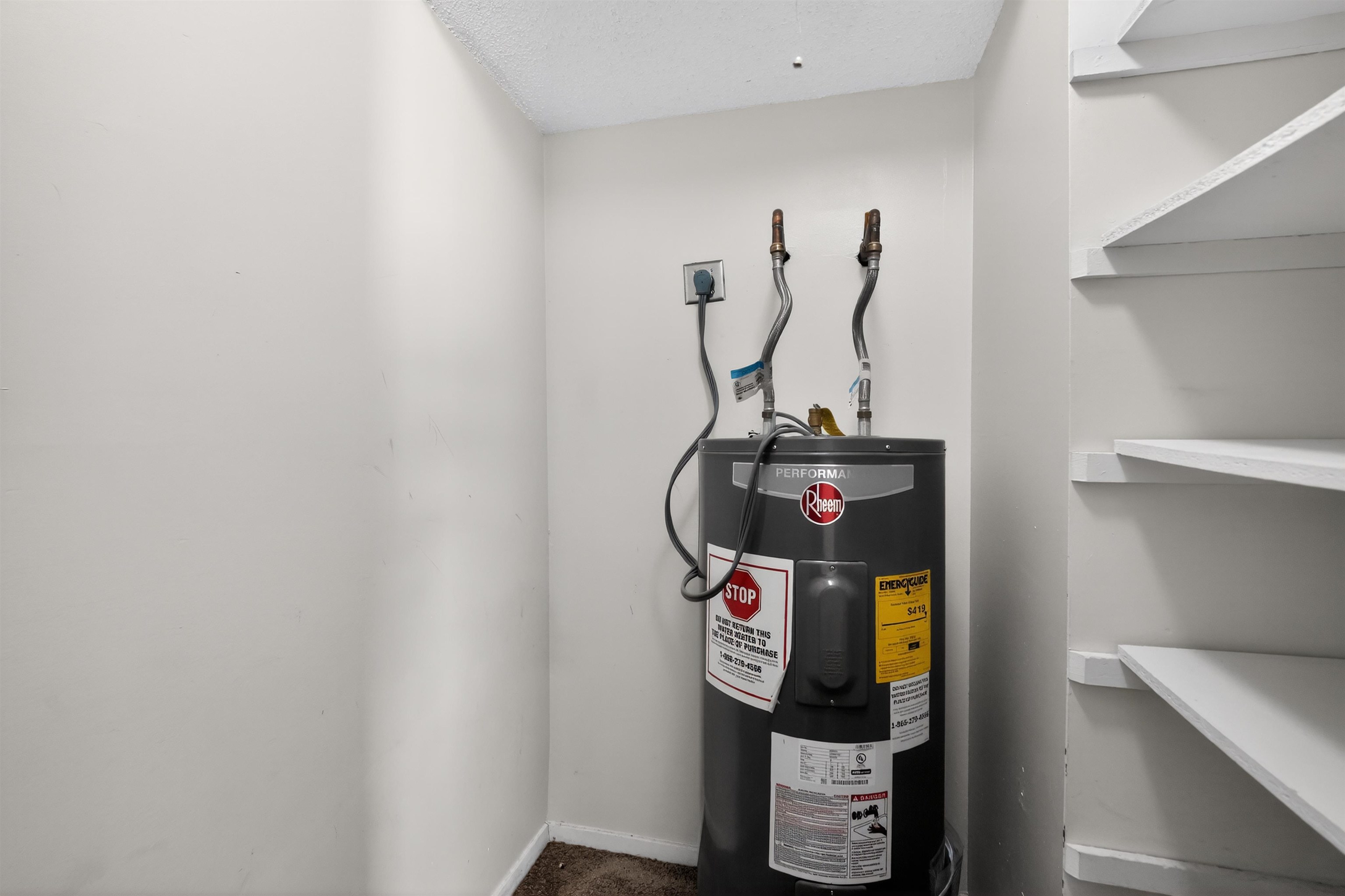 3372 Spring Shadow Drive Memphis, TN 38118 - Photo 33 of 35 Utility closet featuring a water heater and adjacent built-in shelving