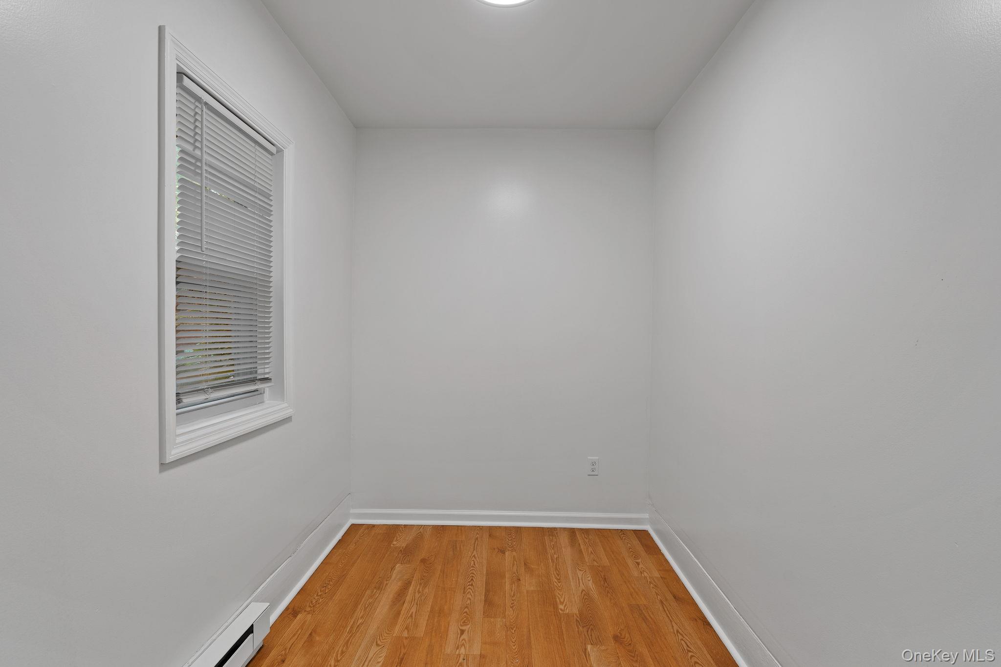 93 Delafield Street Poughkeepsie, NY 12601 - Photo 14 of 27 Unfurnished room with light wood-style floors and a baseboard radiator