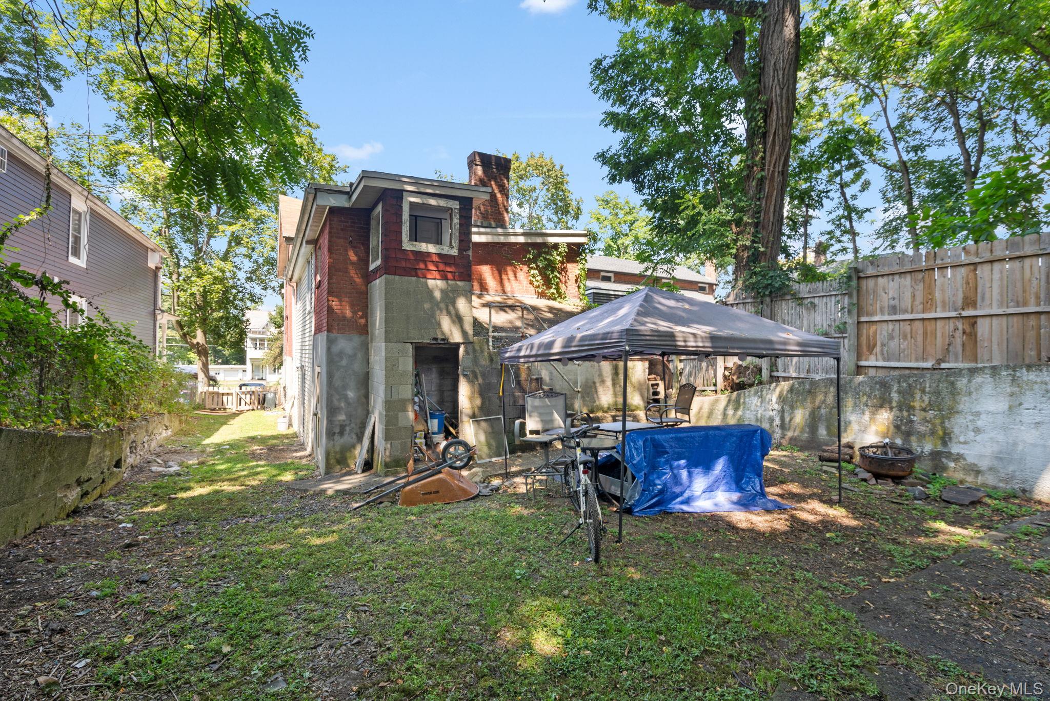 93 Delafield Street Poughkeepsie, NY 12601 - Photo 24 of 27 Rear view of house with a chimney and concrete block siding