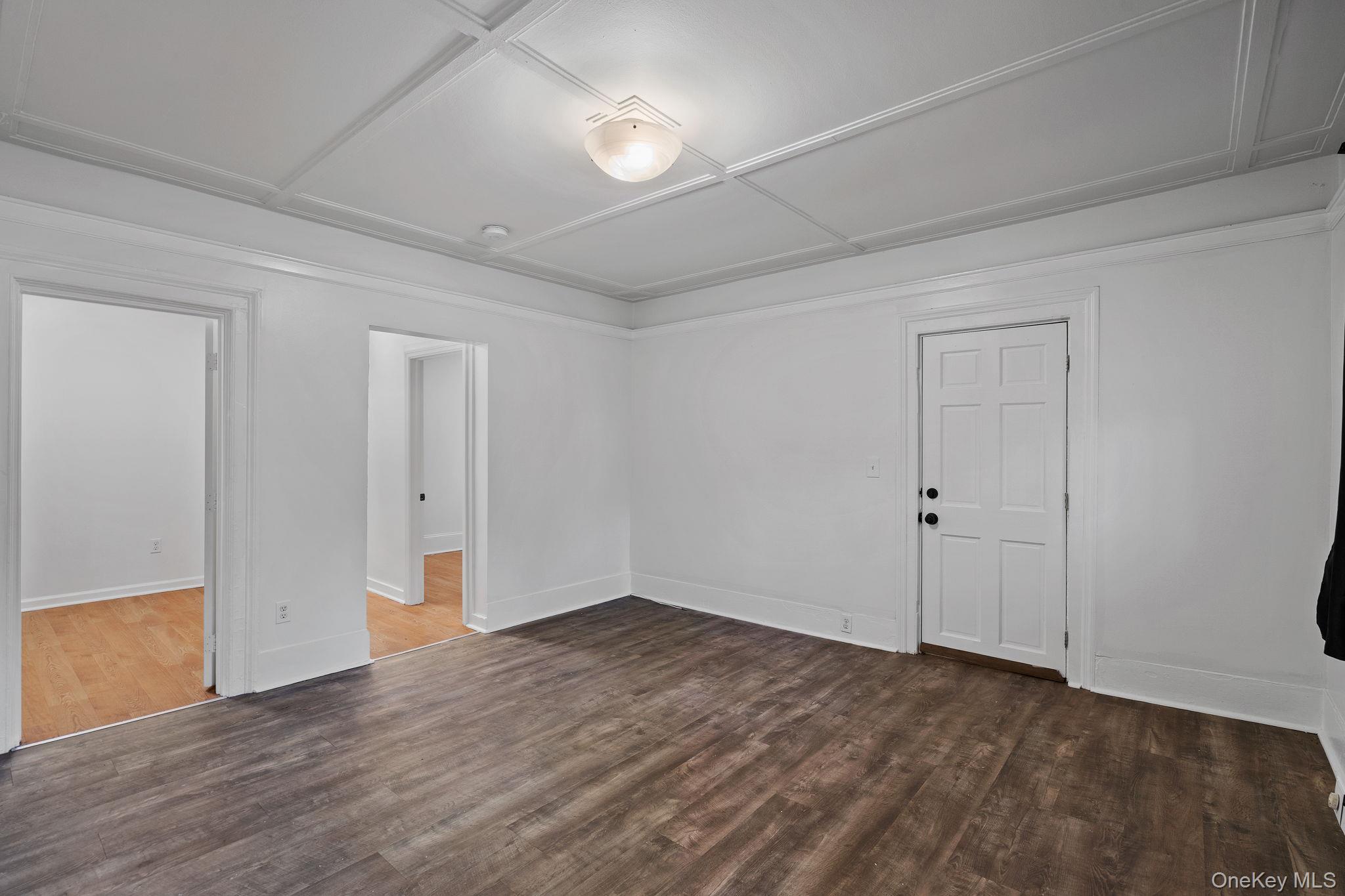 93 Delafield Street Poughkeepsie, NY 12601 - Photo 5 of 27 Spare room featuring dark wood-style flooring and baseboards