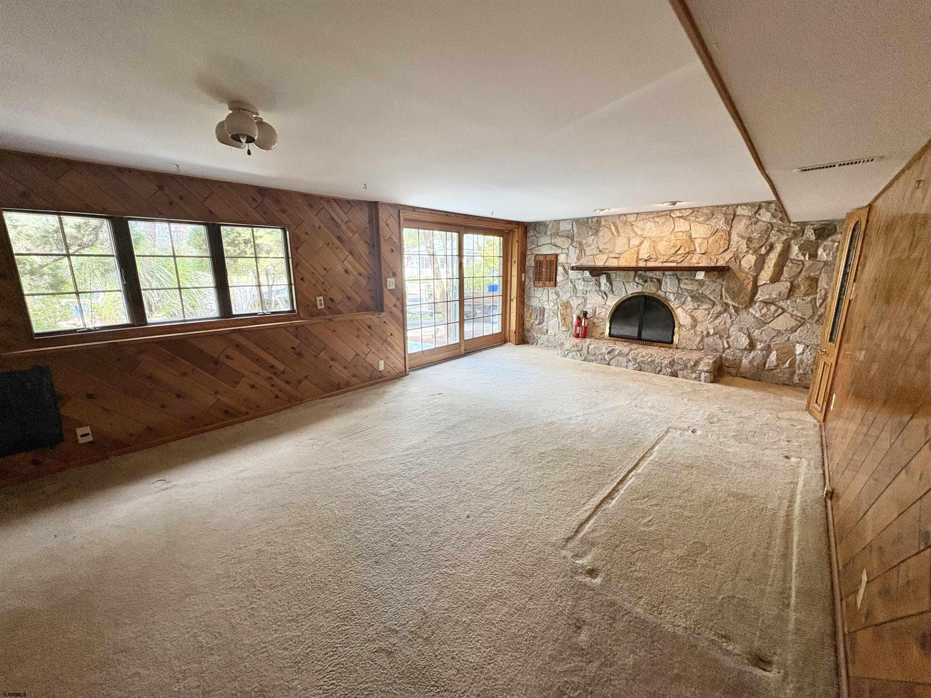 101 Haddon Road Somers Point, NJ 08244 - Photo 14 of 18 a view of an empty room with a fireplace and a window