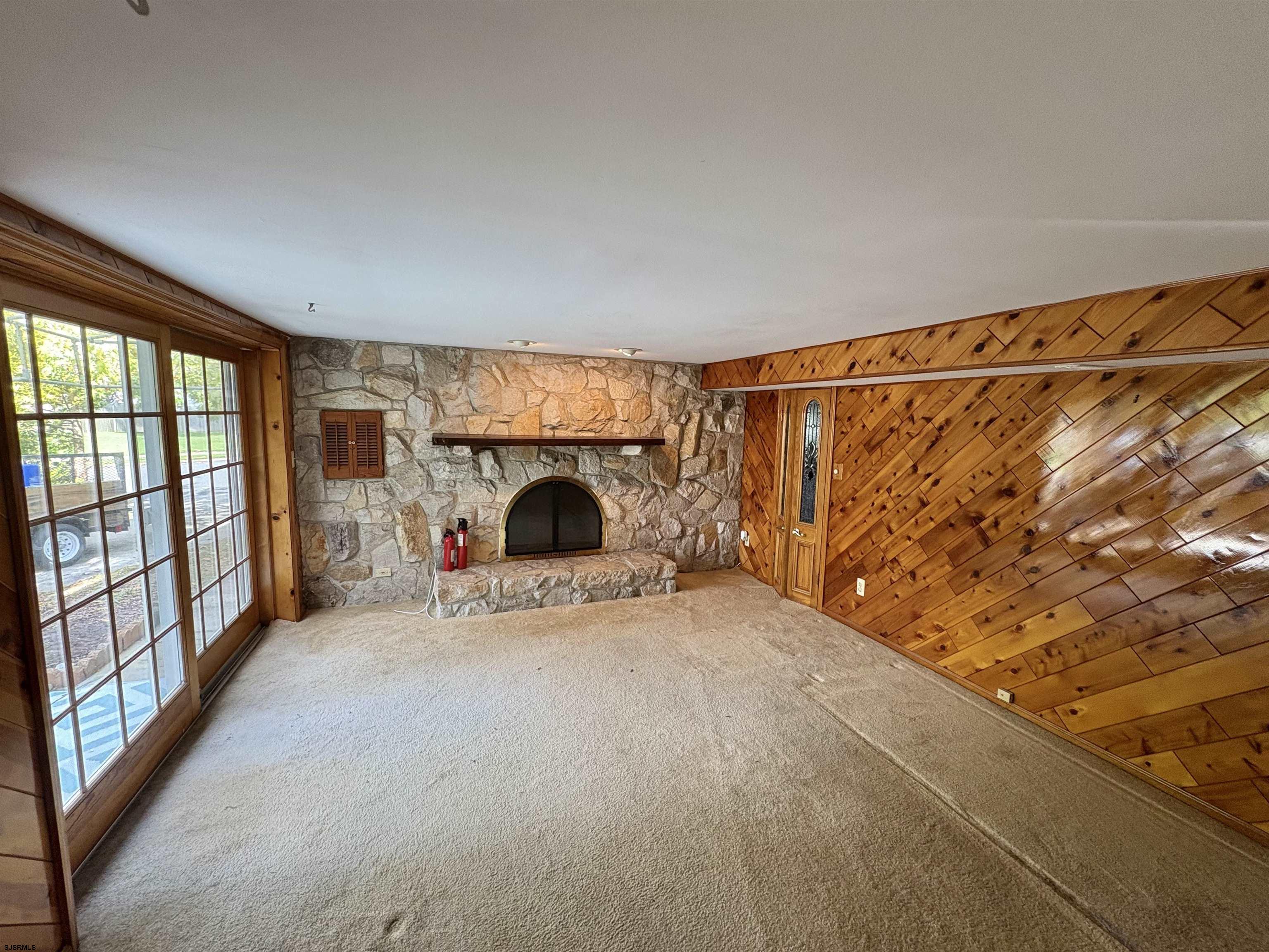 101 Haddon Road Somers Point, NJ 08244 - Photo 15 of 18 a view of an empty room with a fireplace and a window