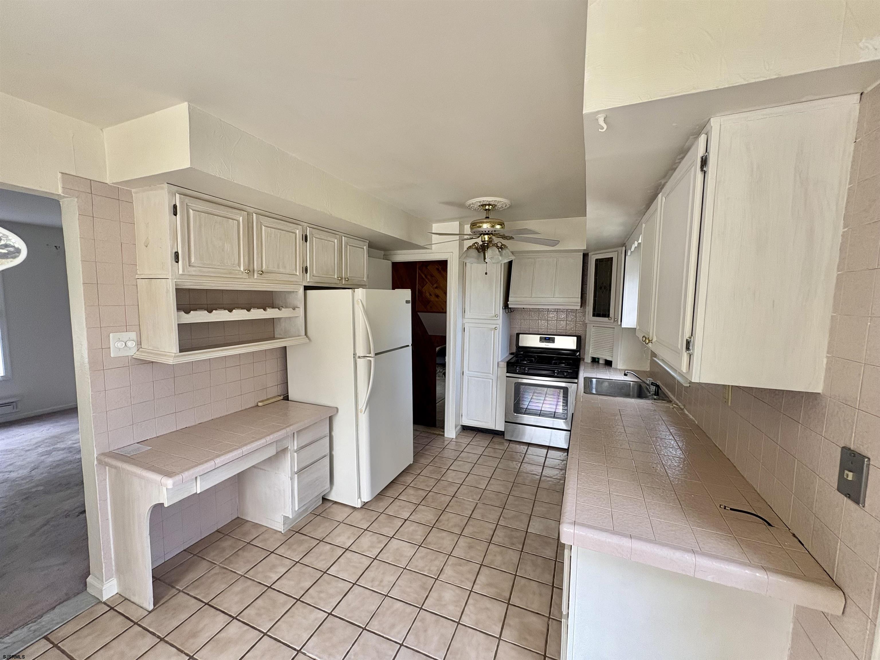 101 Haddon Road Somers Point, NJ 08244 - Photo 4 of 18 a kitchen with granite countertop a refrigerator and a stove top oven
