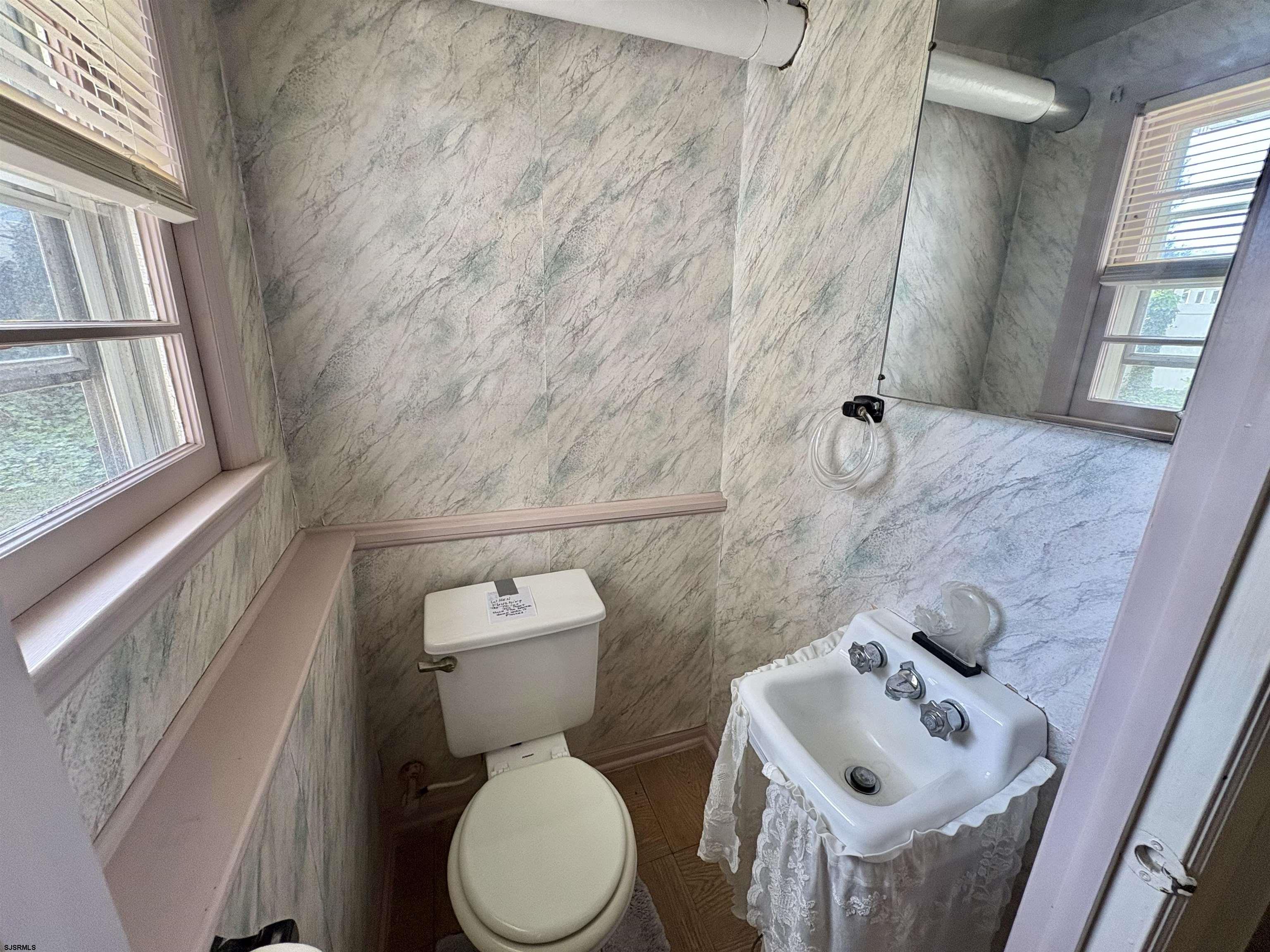 101 Haddon Road Somers Point, NJ 08244 - Photo 7 of 18 a white toilet sitting next to a bathroom sink and a tub