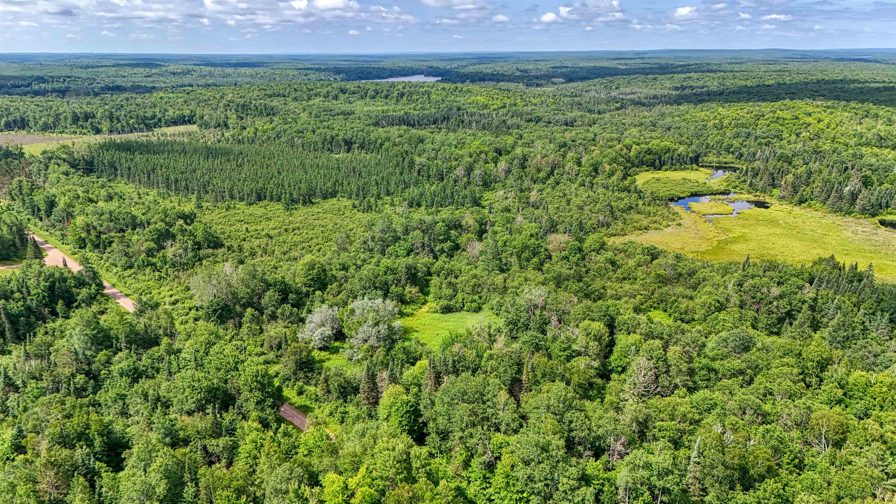 8143 Wright Road Winter, WI 54896 - Photo 22 of 24 Aerial view of property's location featuring a heavily wooded area and a nearby body of water