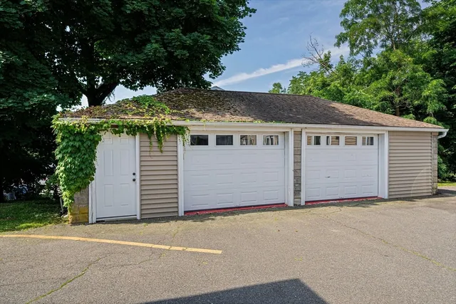 a view of a house with a yard and garage