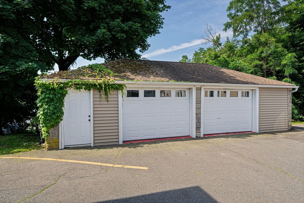 14 Hartwell Street, Unit B Waltham, MA 02453 - Photo 13 of 24 a view of a house with a yard and garage