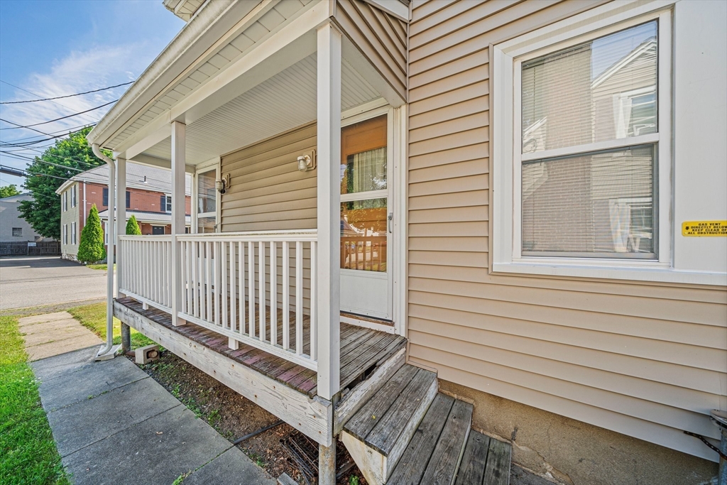14 Hartwell Street, Unit B Waltham, MA 02453 - Photo 15 of 24 a view of a house with a small yard and wooden floor and fence