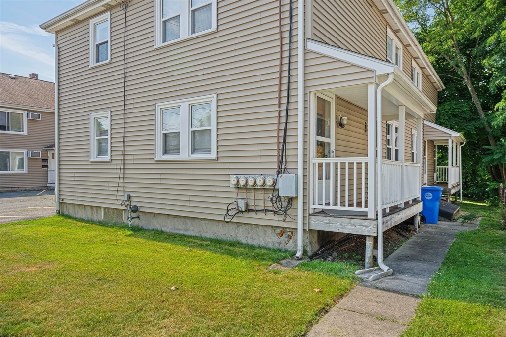 14 Hartwell Street, Unit B Waltham, MA 02453 - Photo 16 of 24 a backyard of a house with table and chairs