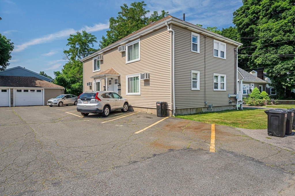 14 Hartwell Street, Unit B Waltham, MA 02453 - Photo 17 of 24 a car parked in front of white house