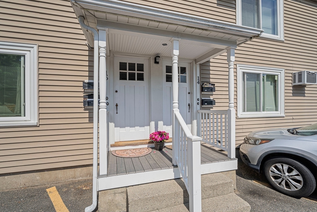 14 Hartwell Street, Unit B Waltham, MA 02453 - Photo 21 of 24 a front view of a house with parking