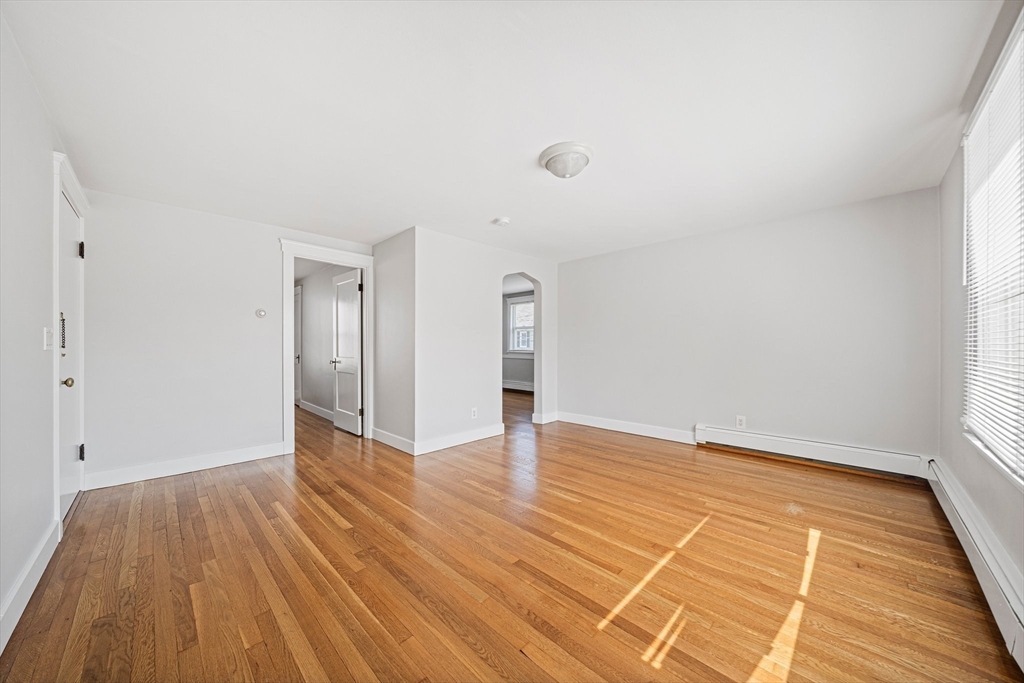 14 Hartwell Street, Unit B Waltham, MA 02453 - Photo 8 of 24 a view of an empty room with wooden floor