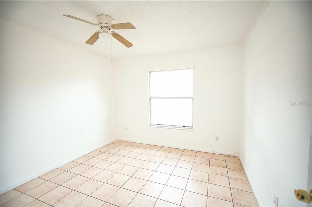 606 Water Road Ocala, FL 34472 - Photo 22 of 34 an empty room with a white cabinet and a window