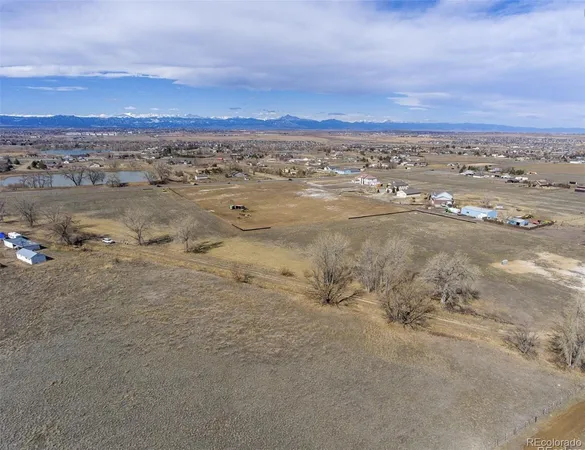 an aerial view of ocean with residential houses with outdoor space