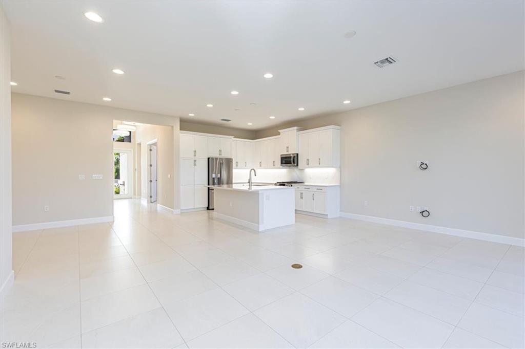 2749 Durham Circle Naples, FL 34112 - Photo 29 of 30 a view of a kitchen with white cabinets