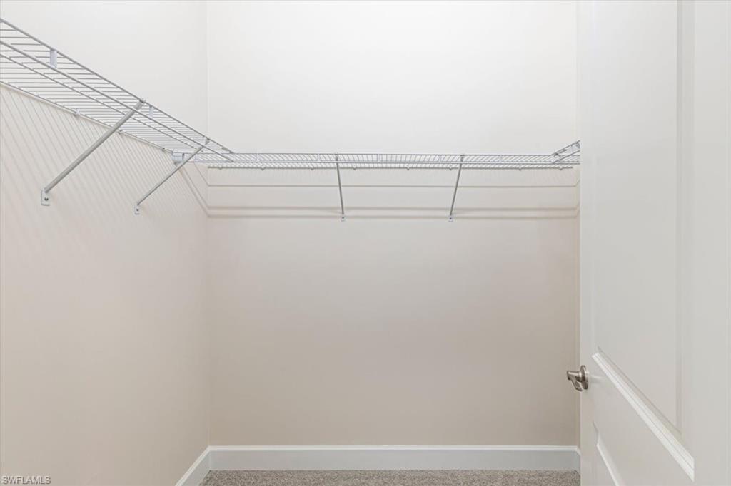2749 Durham Circle Naples, FL 34112 - Photo 19 of 30 a view of small space with racks on the wall