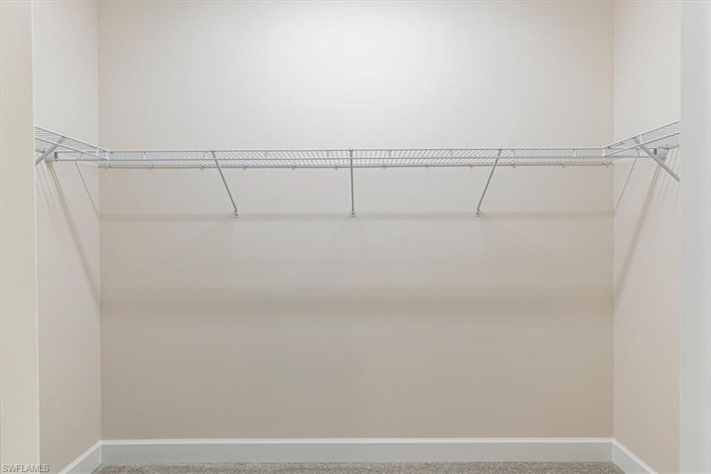 2749 Durham Circle Naples, FL 34112 - Photo 20 of 30 a view of a room with racks on the wall