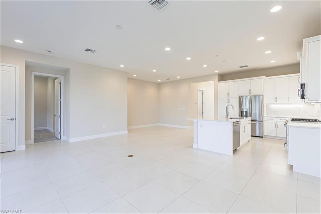 2749 Durham Circle Naples, FL 34112 - Photo 27 of 30 a view of kitchen with kitchen island white cabinets and refrigerator