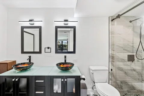 a bathroom with a toilet and a shower