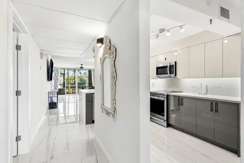 a open kitchen with white cabinets and stainless steel appliances