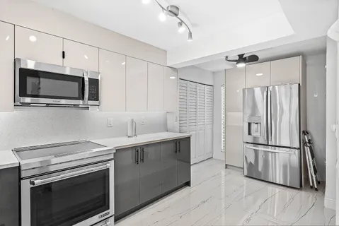 a kitchen with a sink stove and refrigerator