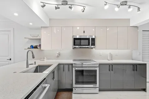 a kitchen with a sink a stove and cabinets