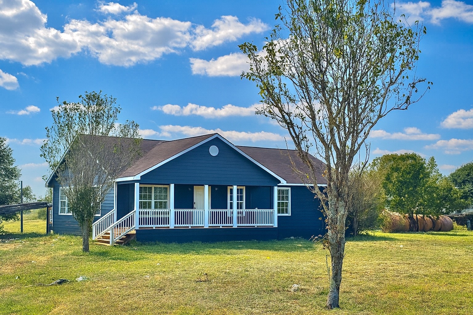 a view of a house with swimming pool and a yard