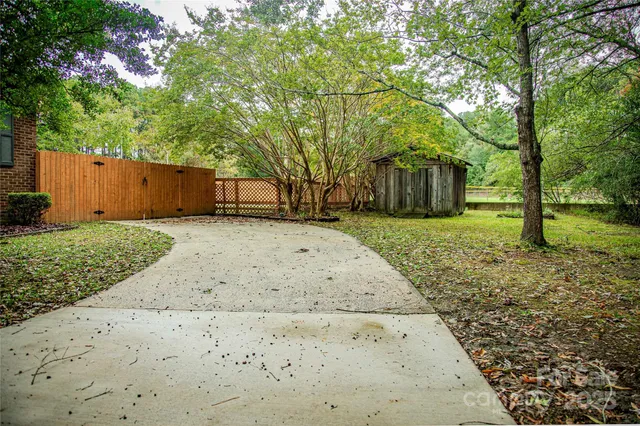 a view of a backyard with large trees