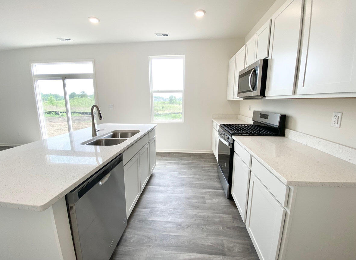 585 Marcella Street Hebron, IN 46341 - Photo 6 of 21 a kitchen with stainless steel appliances granite countertop lots of counter top space and a window