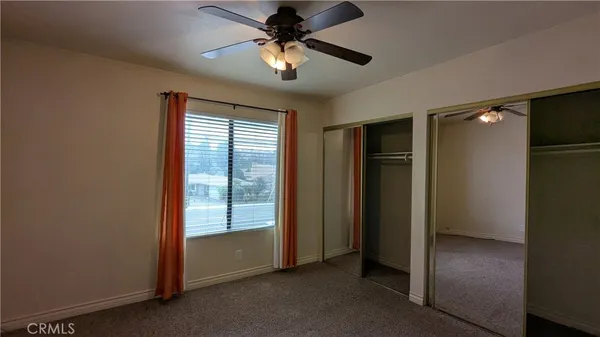 a view of a livingroom with a ceiling fan and window