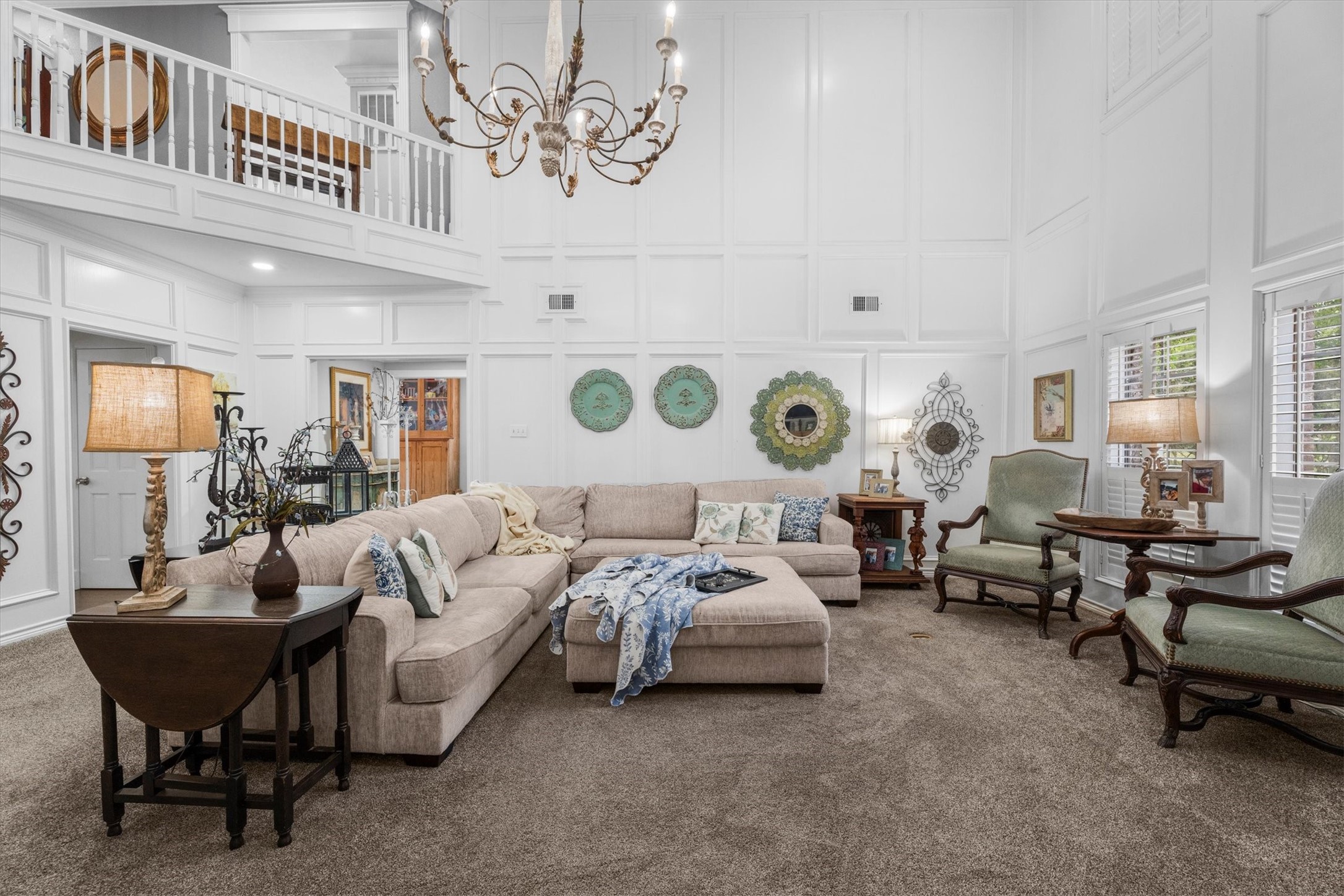 15902 Guinstead Drive Spring, TX 77379 - Photo 13 of 42 Living room featuring a high ceiling, beautiful chandelier and plush carpet.