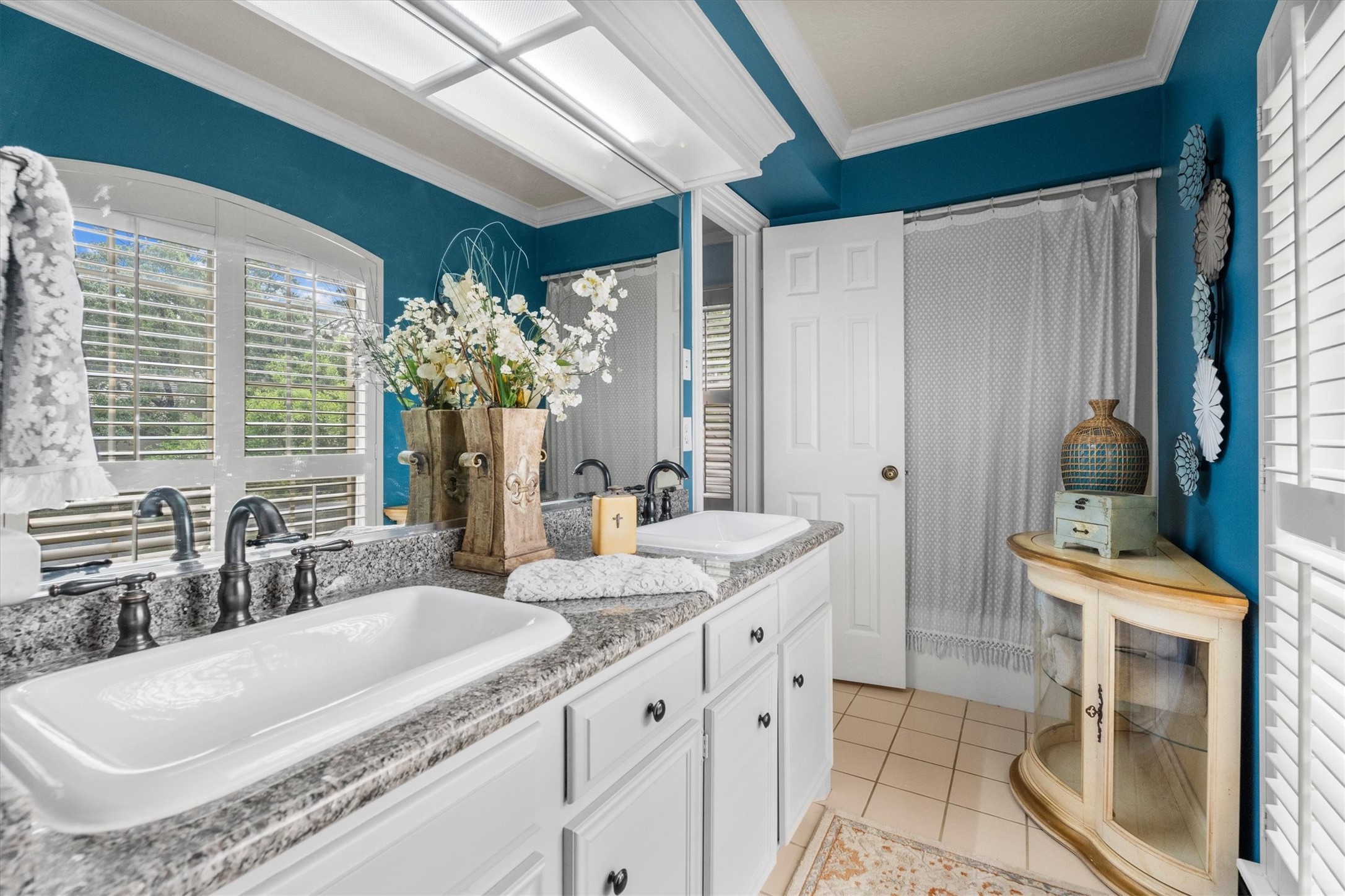 15902 Guinstead Drive Spring, TX 77379 - Photo 30 of 42 Bathroom featuring a double vanity with granite countertops, elegant fixtures, and a large mirror.