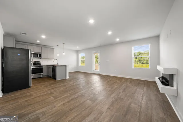 a view of a kitchen with a sink and a refrigerator