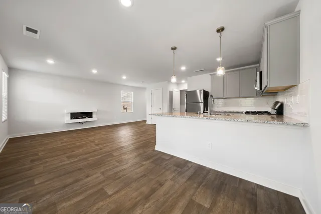 a view of kitchen with kitchen island microwave and stove