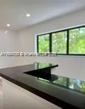 a view of a large window with kitchen view