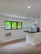 a kitchen with stainless steel appliances granite countertop a large window