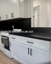 a close view of a stove a microwave and cabinets