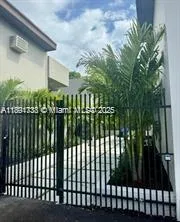a view of a yard in front of house with a fountain