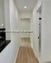 a view of a hallway with a white cabinet