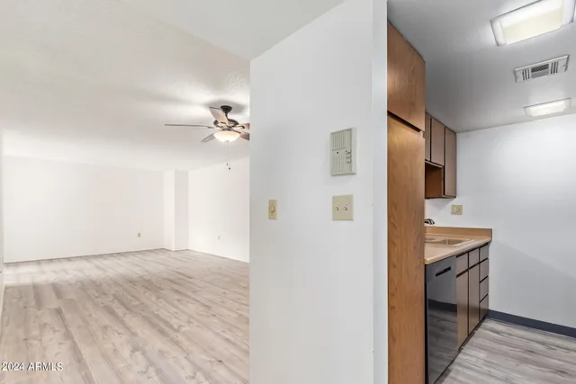 a view of empty room with wooden floor