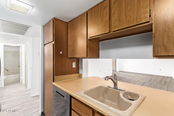 a kitchen with stainless steel appliances a sink a stove and a microwave