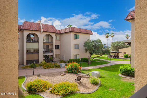 a view of a patio with a table and chairs