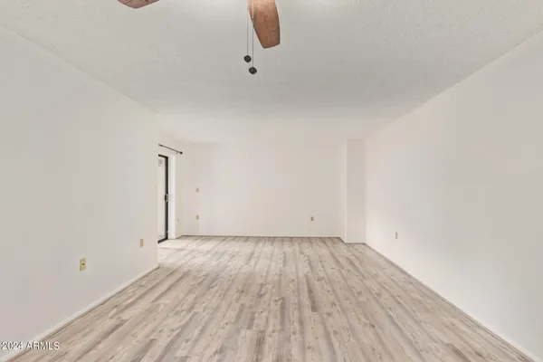 a view of a room with wooden floor