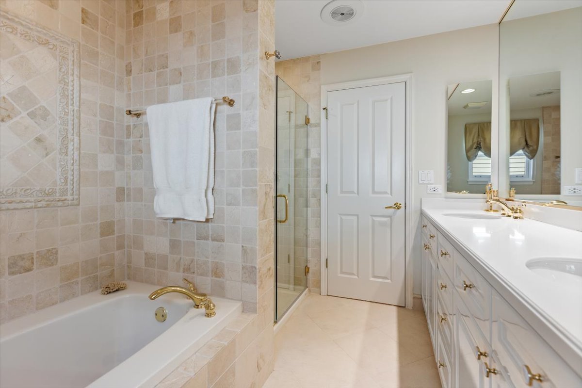 332 West Goethe Street Chicago, IL 60610 - Photo 13 of 29 a spacious bathroom with a granite countertop sink a mirror a bathtub and shower